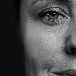 Monochrome portrait of pretty middle aged woman with wrinkled skin